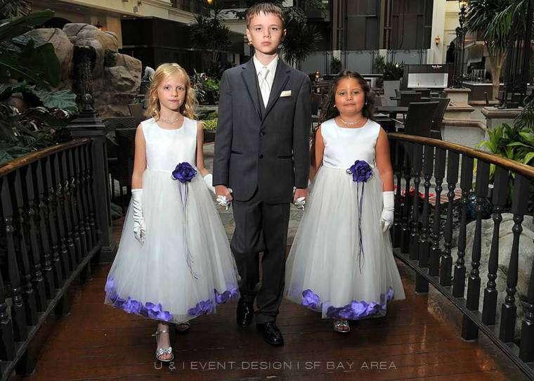 purple flower girl dresses and ring bearer suit at event by bay area wedding planner