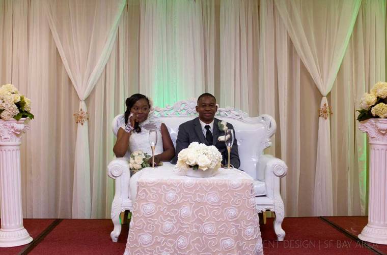 bride and groom sitting at sweetheart table designed by bay area wedding decorator and florist