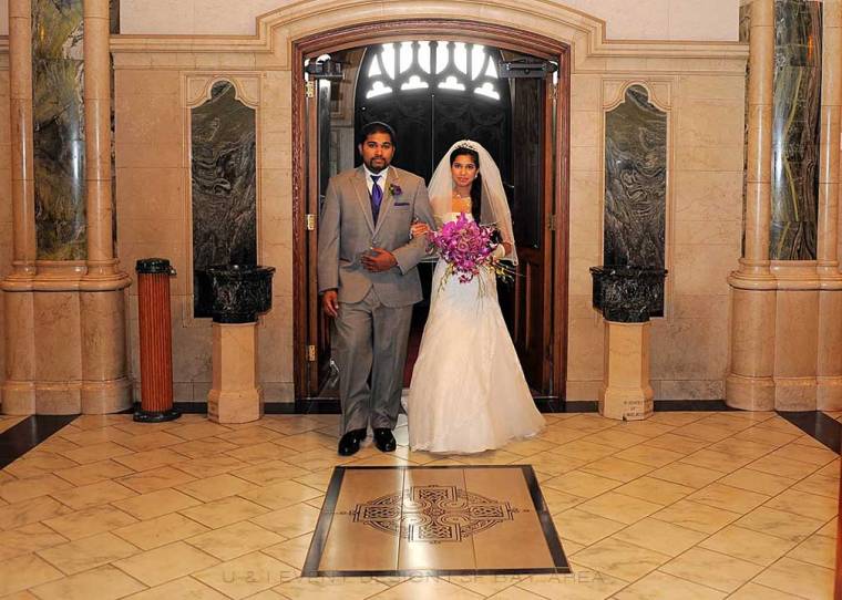 bride holding purple orchid bouquet getting ready to walk down aisle at event by san francisco wedding planner