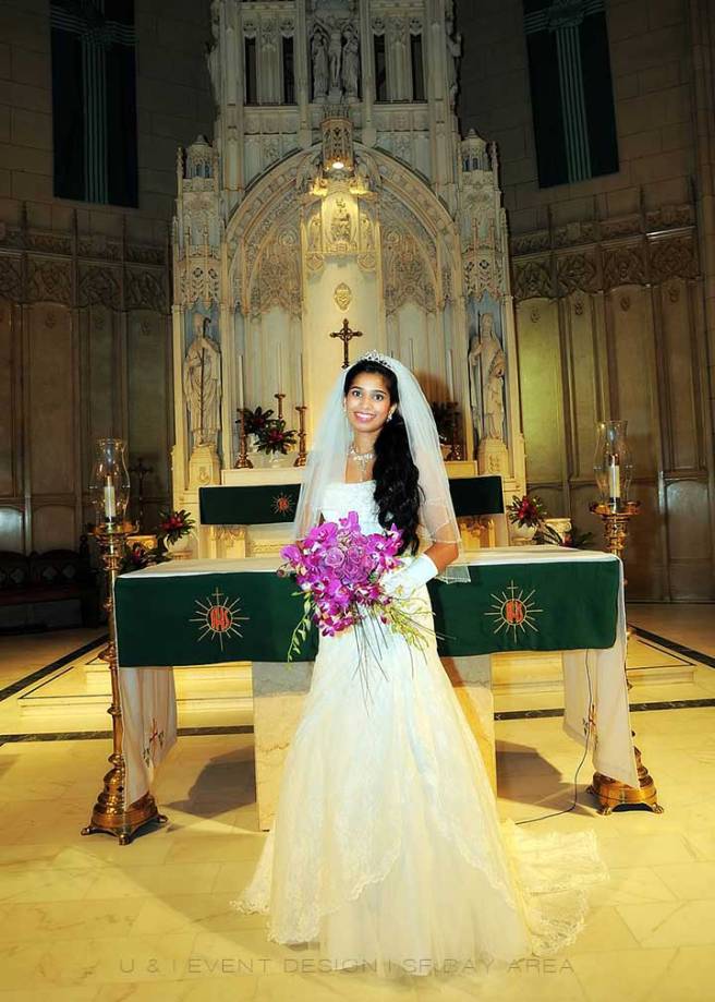 indian bride holding purple flowers after ceremony at saint patricks catholic church san francisco wedding venue