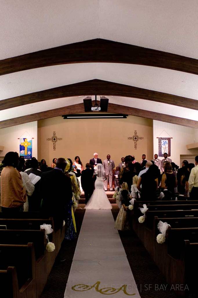 bride and groom walking down monogrammed aisle by east bay area wedding planner at walnut creek california ceremony venue