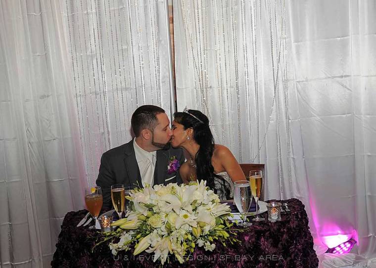 newlyweds stealing a kiss at their san francisco wedding reception venue designed by bay area planner